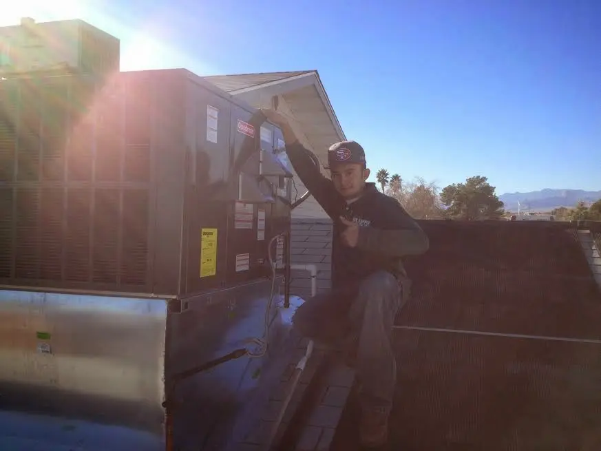HVAC technician performing HVAC Inspection on a rooftop unit in Edgewood